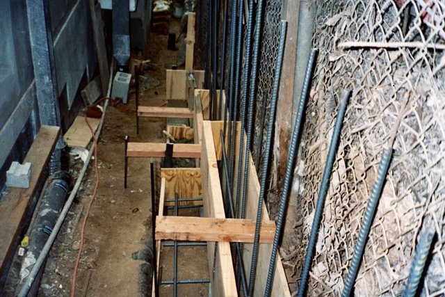 Hillside retaining wall footing forms