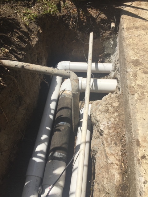 French Drains Extend Through Concrete Wall For Driveway Discharge