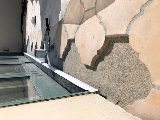 Waterproofing applied to deck mortar bed prior to installing deck tiles