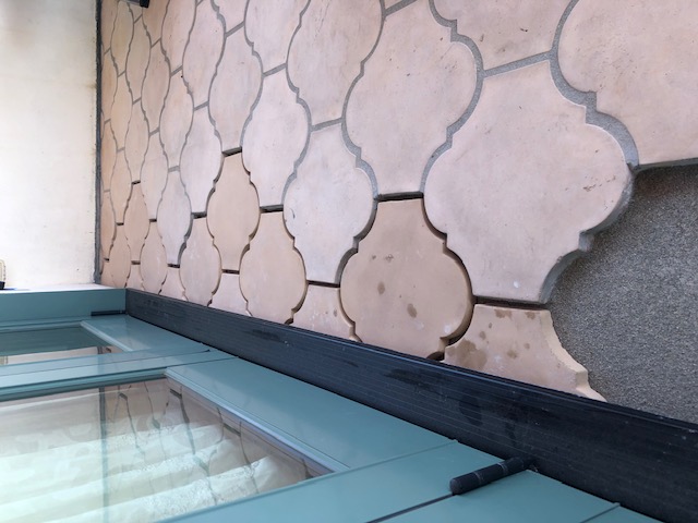 Replacement deck tiles installed over corrected waterproofing