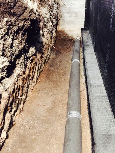 French drain installed adjacent basement footing