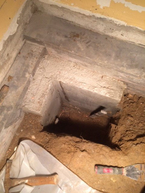 Concrete underpinning basement corner footings