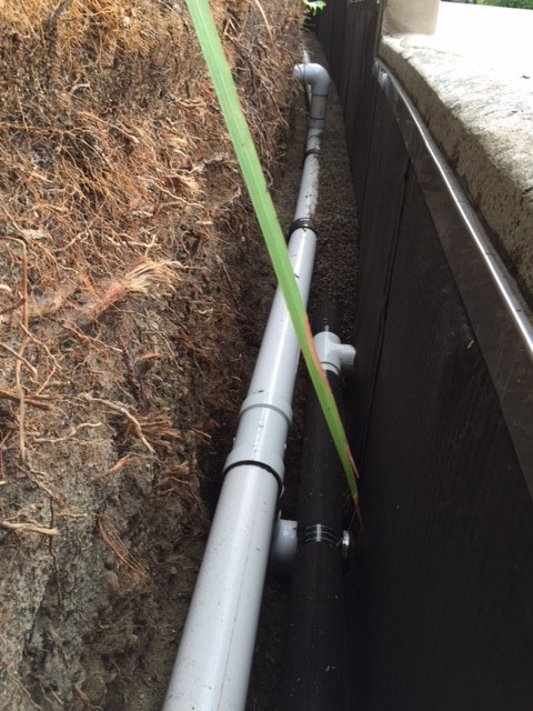 French drain T connection discharge location, base of planter wall