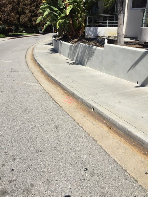 French drains discharge outlets at bottom of planter wall