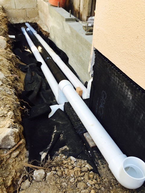 French drain positioned in center of the three drain pipes