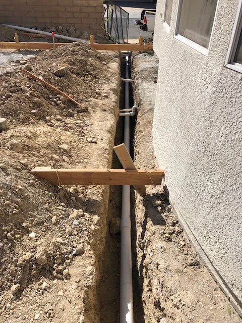 French drain transitions to solid pipe draining to street