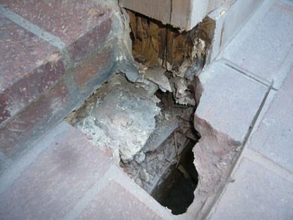 Invasive investigation to elevated courtyard deck at step transition location revealing structural dry rot and no step transition flashings installed