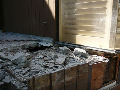 Substandard flashing installation at the elevated courtyard deck / fixed window location causing structural dry rot, termite damage and mold conditions