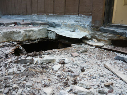 Water intrusion to elevated deck flashing incorrectly installed above sloping cement and wood siding surface creating dry rot, termite damage and mold conditions