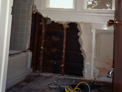 Bathroom remediation includes tile flooring and cast iron tub removal