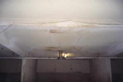 Elevated deck drain leaks creating ceiling water damage